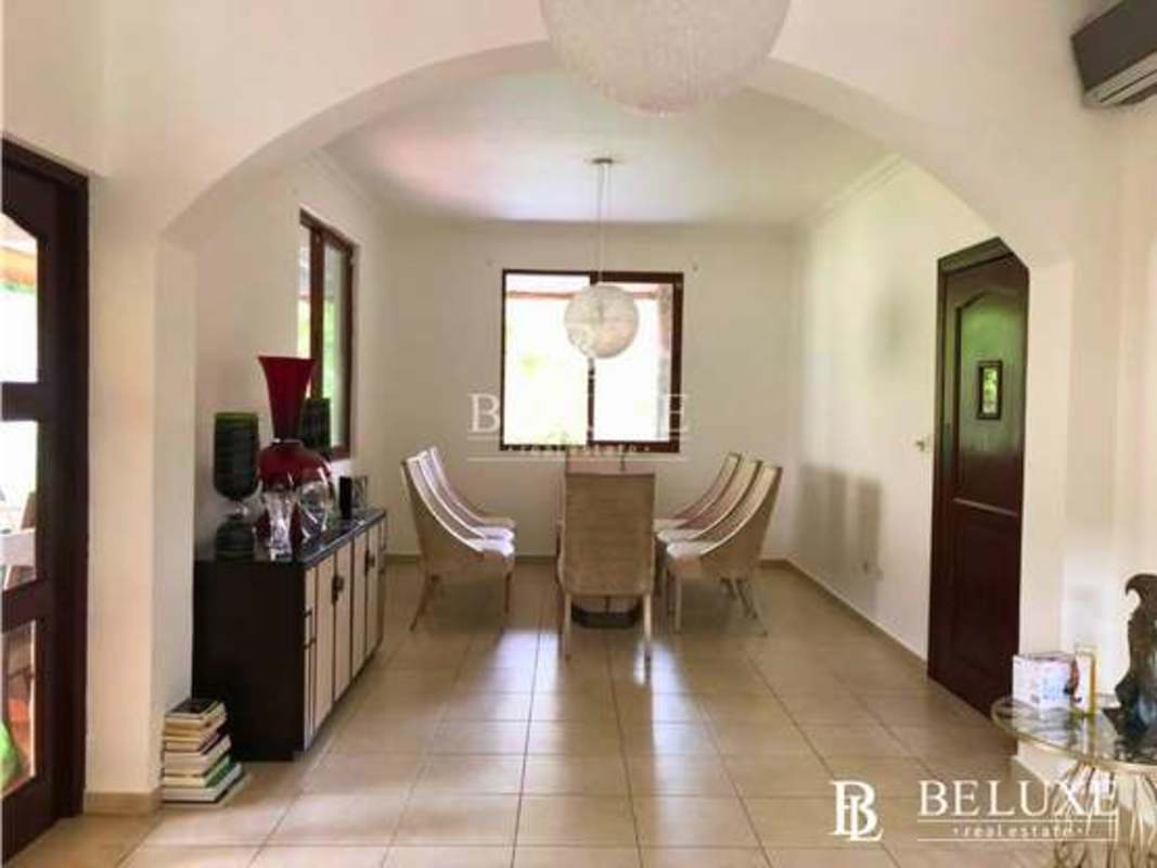 Bright hallway landing with iron railing windows garden view Clayton house