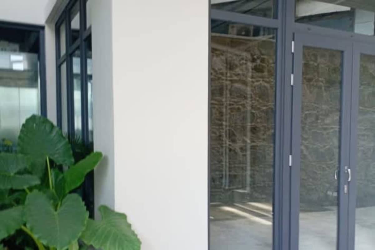 Modern glass corner entry scene with colonial details La Plazuela Casco Viejo