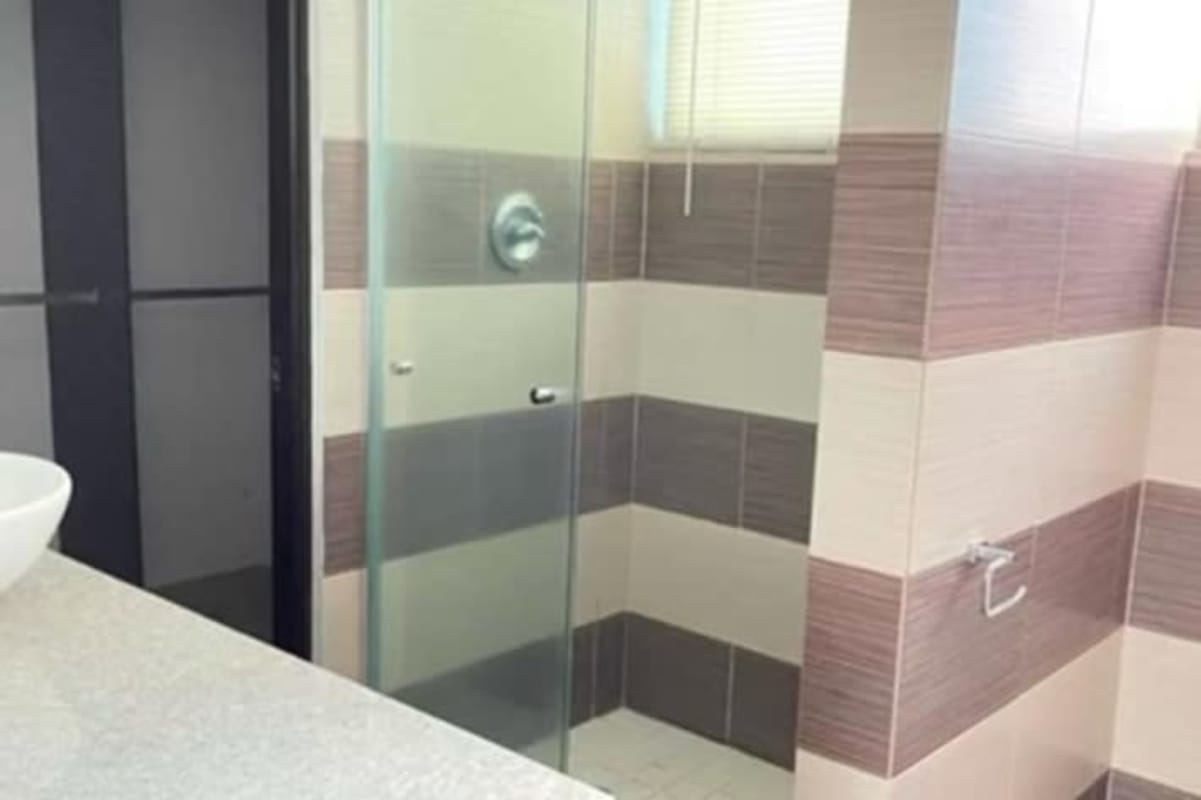 Living room with large sliding doors to balcony city skyline ocean view PH The Palms Panama City