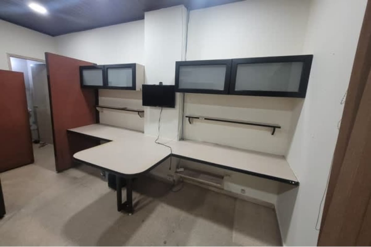 Office workspace with frosted glass overhead cabinets, partitions and monitors in El Dorado business center Panama