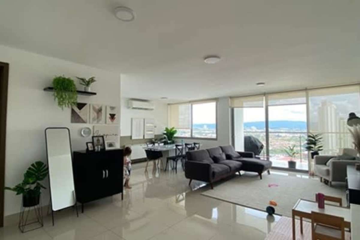 Modern kitchen with granite countertop, white cabinets, and large window PH Bali Costa del Este Panama City
