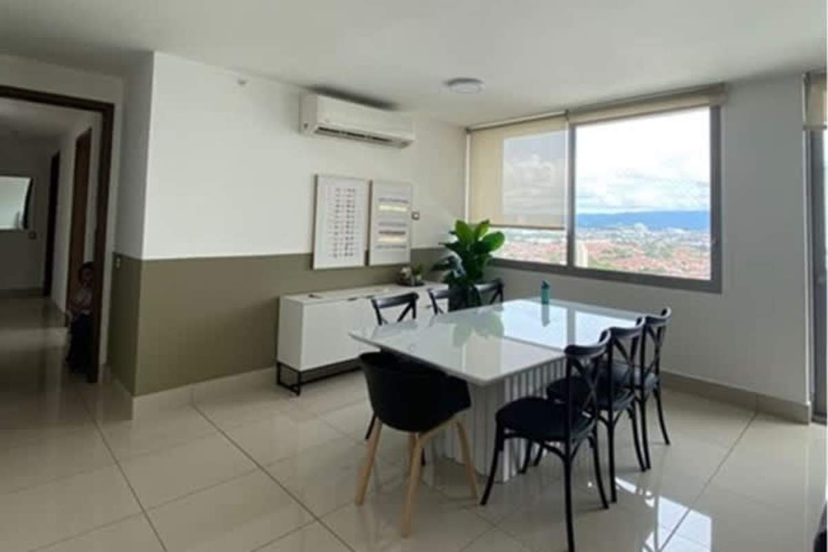 Dining room with large window overlooking Panama City night lights PH Bali Costa del Este