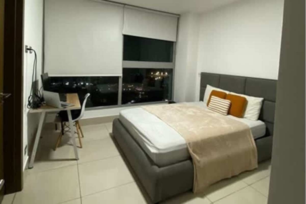 Bedroom with floor-to-ceiling windows offering night city view PH Bali Costa del Este