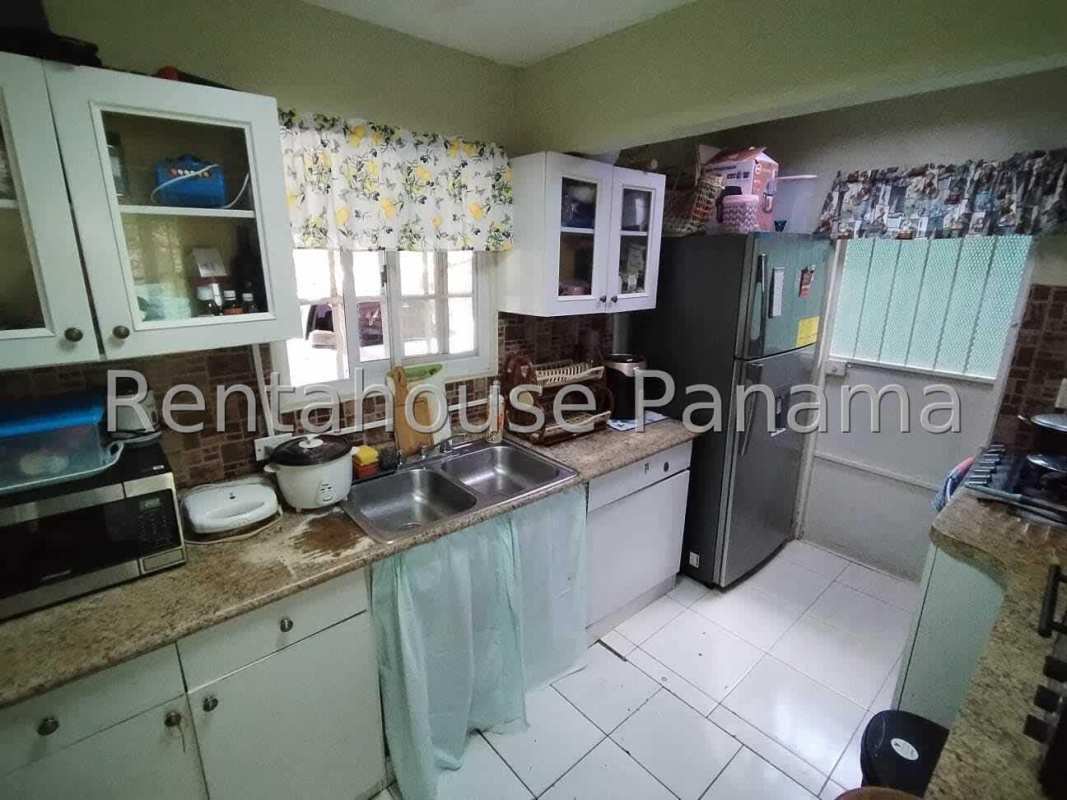 Traditional kitchen with granite countertop and white cabinets Villa Alpina Panama