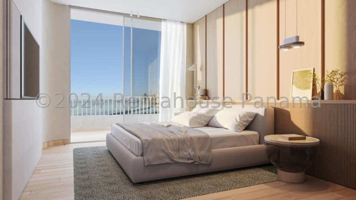 Bedroom with large window facing ocean balcony at Ipanema Residence Costa del Este Panama