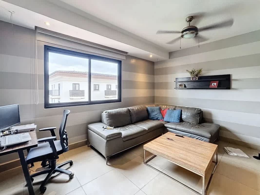 Bright living room with porcelain floors, balcony view to nature at PH Embassy Village Clayton Panama