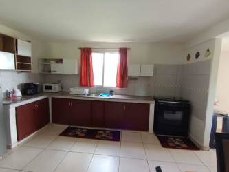 Kitchen with tile floor, cabinets, stove, microwave Bugaba Chiriquí