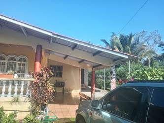 Front garden, covered entry porch, tropical design house Bugaba