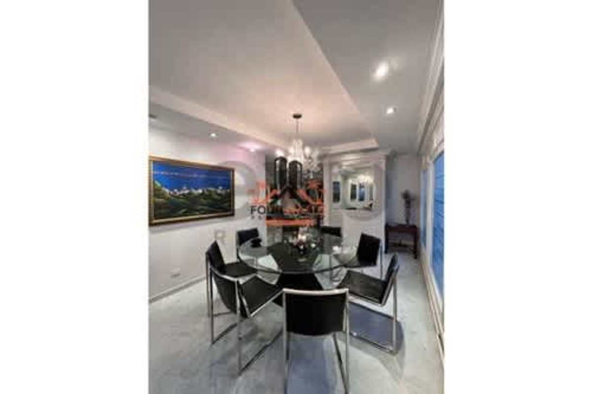 Spacious modern dining room with marble flooring, large windows and upholstered chairs at Punta Paitilla Panama