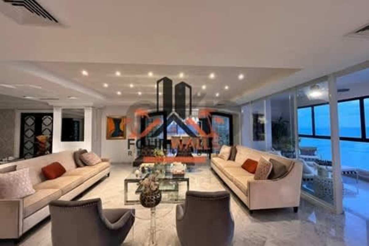 Modern living room with marble floors, ceiling lights, large windows and ocean view in luxury Punta Paitilla tower