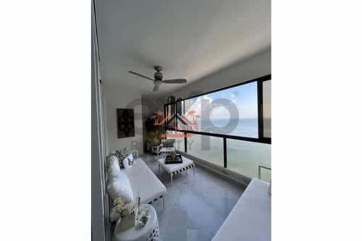 Modern sunroom enclosed balcony with floor-to-ceiling windows ocean view at PH Punta del Sol Punta Paitilla