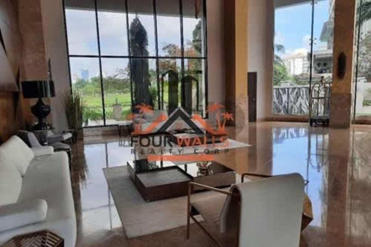 Modern living room with panoramic city views through floor-to-ceiling windows at PH La Vista Santa Maria Panama