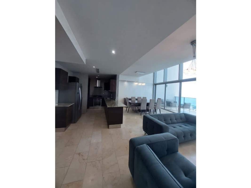 Double-height living and dining area with ocean views at Grand Tower Punta Pacifica Panama