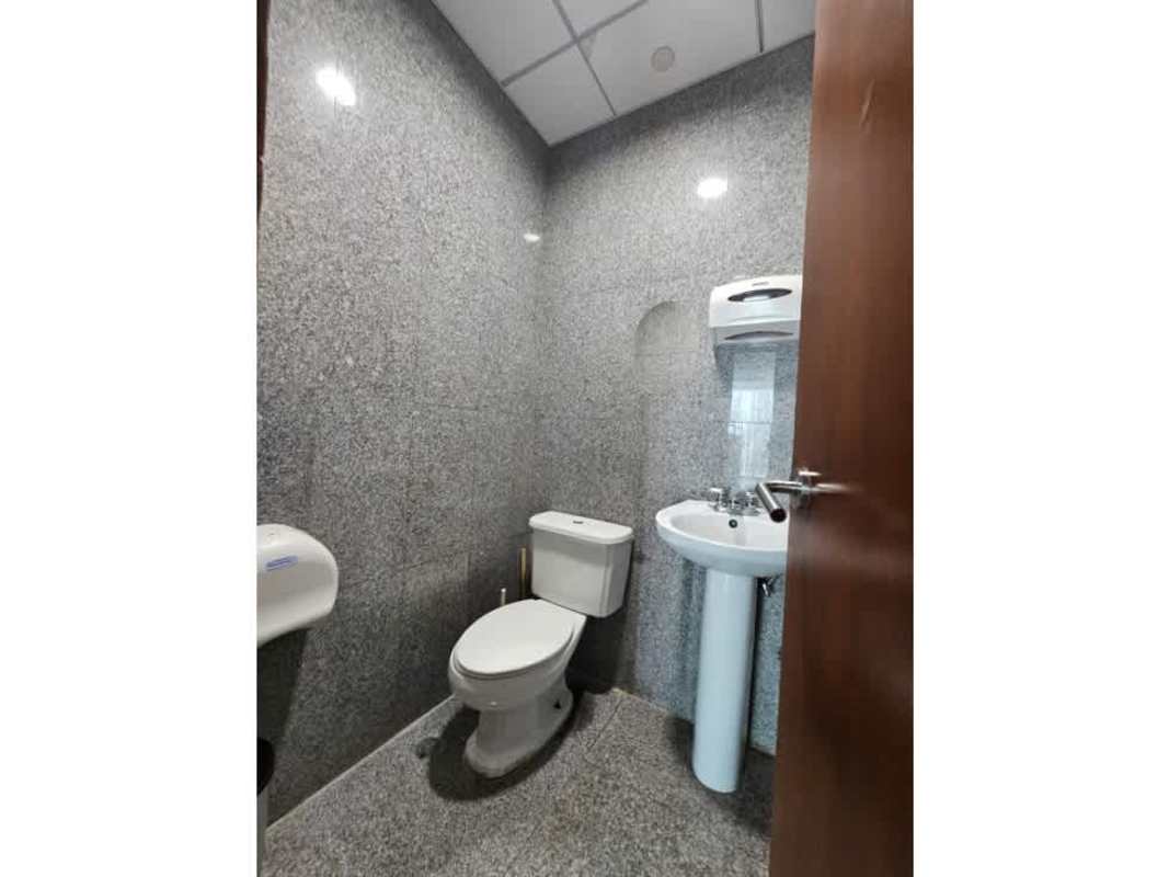 Modern commercial bathroom with granite walls and pedestal sink in PH Global Bank Panama City