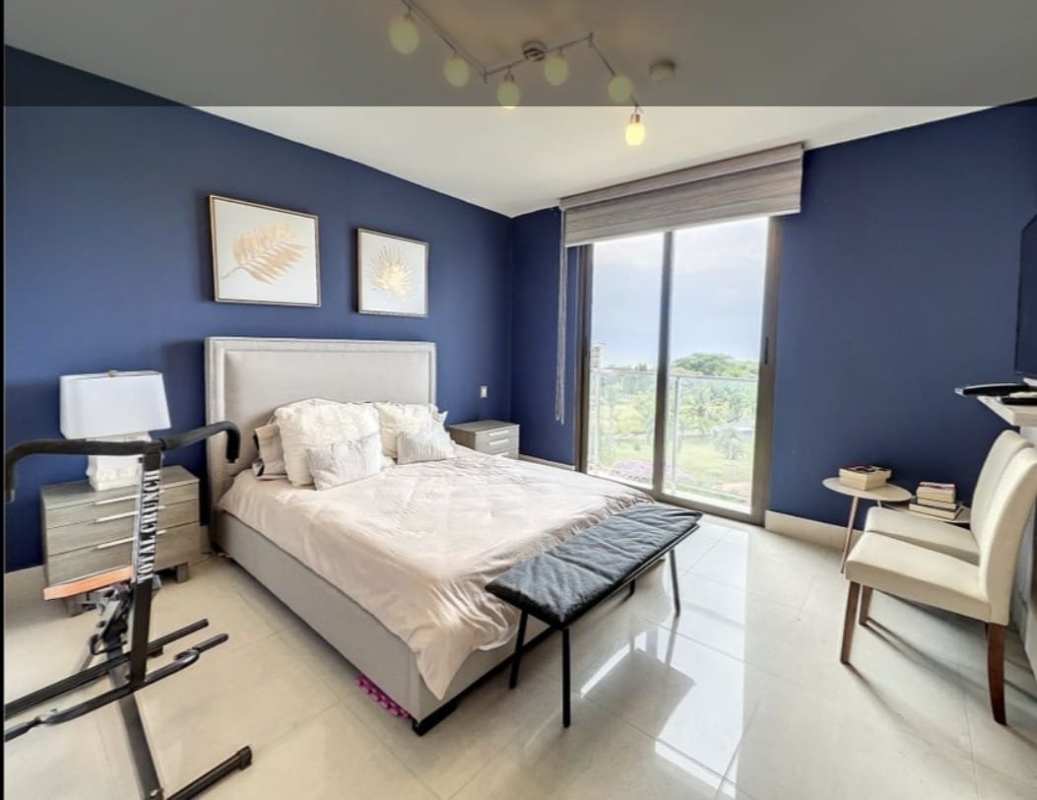 Spacious bedroom with sliding glass doors, blue accent wall and balcony PH Perlamar Tower 300 Casamar San Francisco Panama