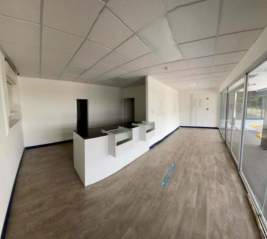 Minimalist kitchenette with sink refrigerator space and bathroom view in Plaza Procenter Costa del Este Panama