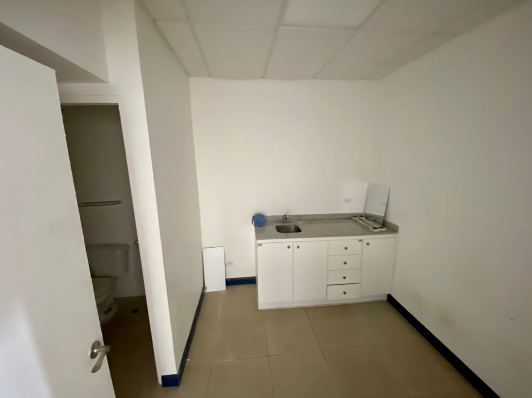 Lobby area with reception counter glass wall and ceiling tiles in Plaza Procenter Costa del Este Panama