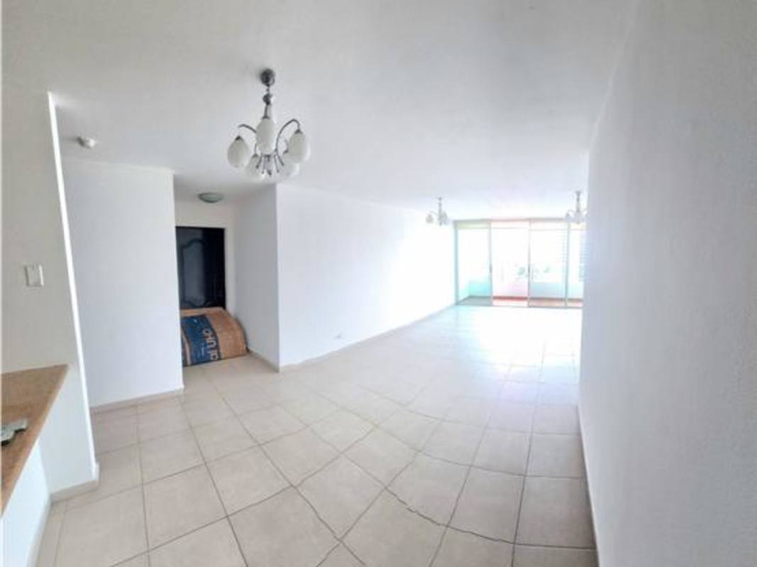 Living room space with tile flooring open to balcony with skyline view in PH Terrawind San Francisco Panama