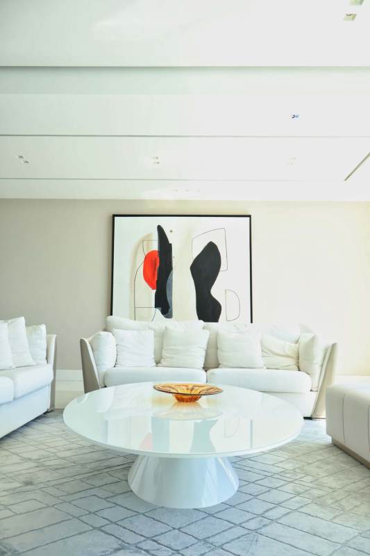 Bright open living room with marble floors, floor-to-ceiling glass, balcony access, ocean and skyline view, Punta Pacifica Panama