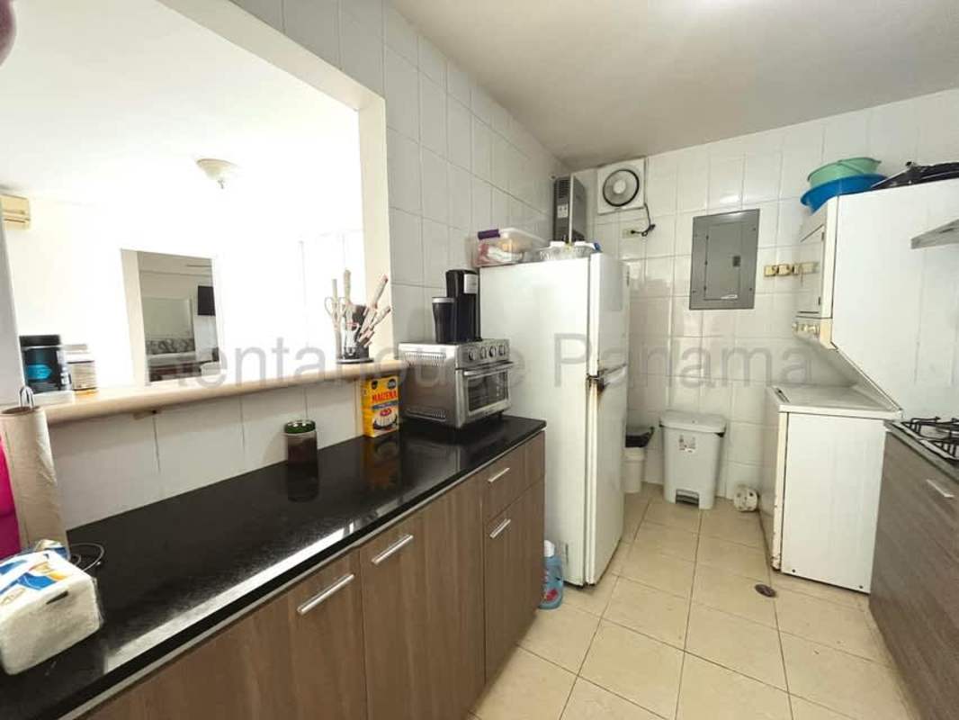 Functional kitchen with granite counters and modern cabinetry in Edison Park apartment