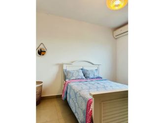 Main bedroom with modern style, split AC, and large window in Playa Blanca Resort Panama