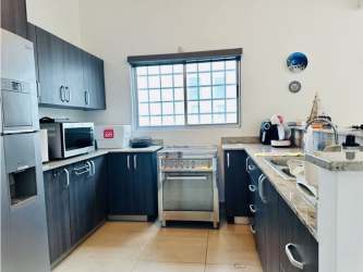 Covered terrace area with ceiling fans and garden view in Napa Valley Playa Blanca house Panama