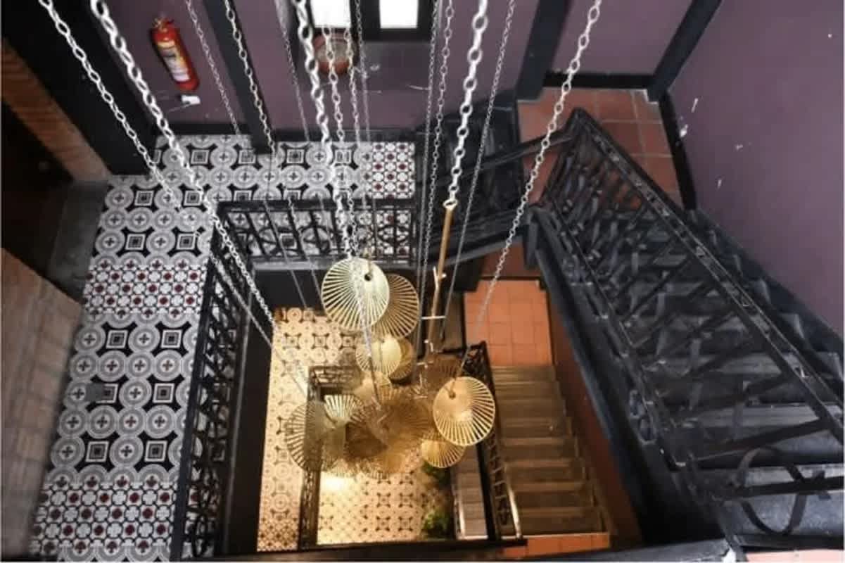 Colonial staircase with vintage chandelier inside Casa Feraud Casco Viejo Panama City