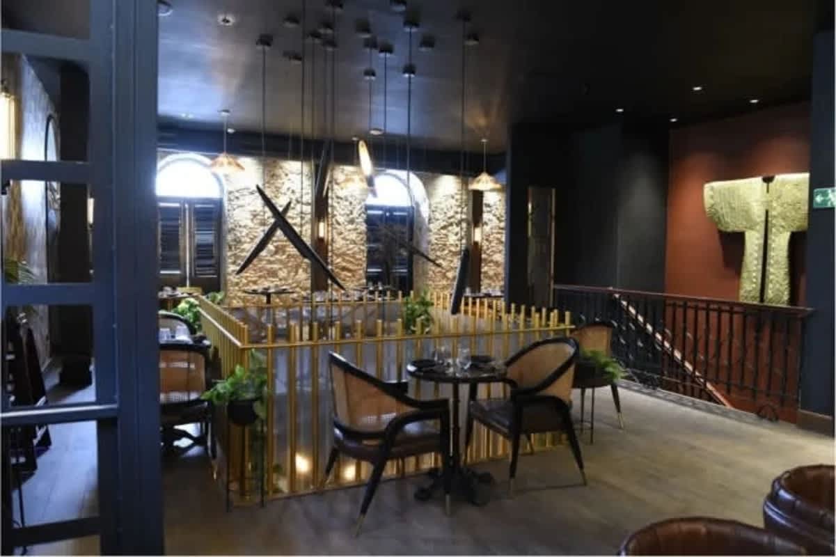 Restaurant dining room with mural, wood windows and ambient lighting Casa Feraud Casco Viejo