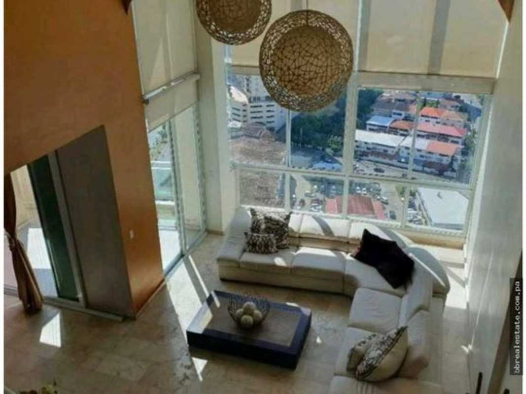 Open plan living-dining with double height ceiling, panoramic ocean view, corner sofa, pendant light in PH Costa Pacifica Panama