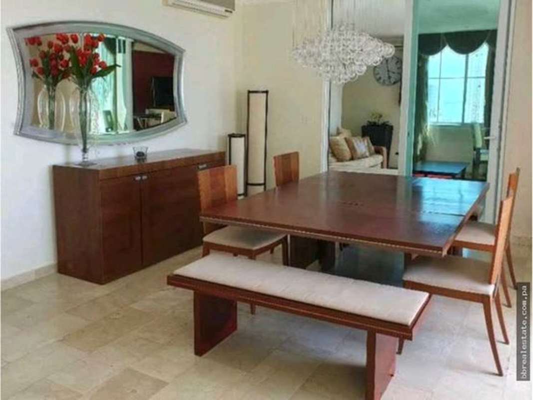 Modern dining room with wooden table bench seating pendant lamp in PH Costa Pacifica Punta Pacifica Panama City