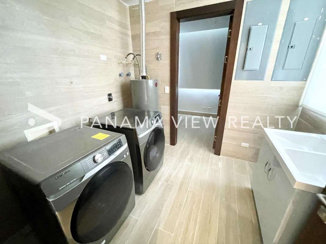 Laundry room equipped with washer, dryer, sink and water heater in The Towers Punta Paitilla apartment