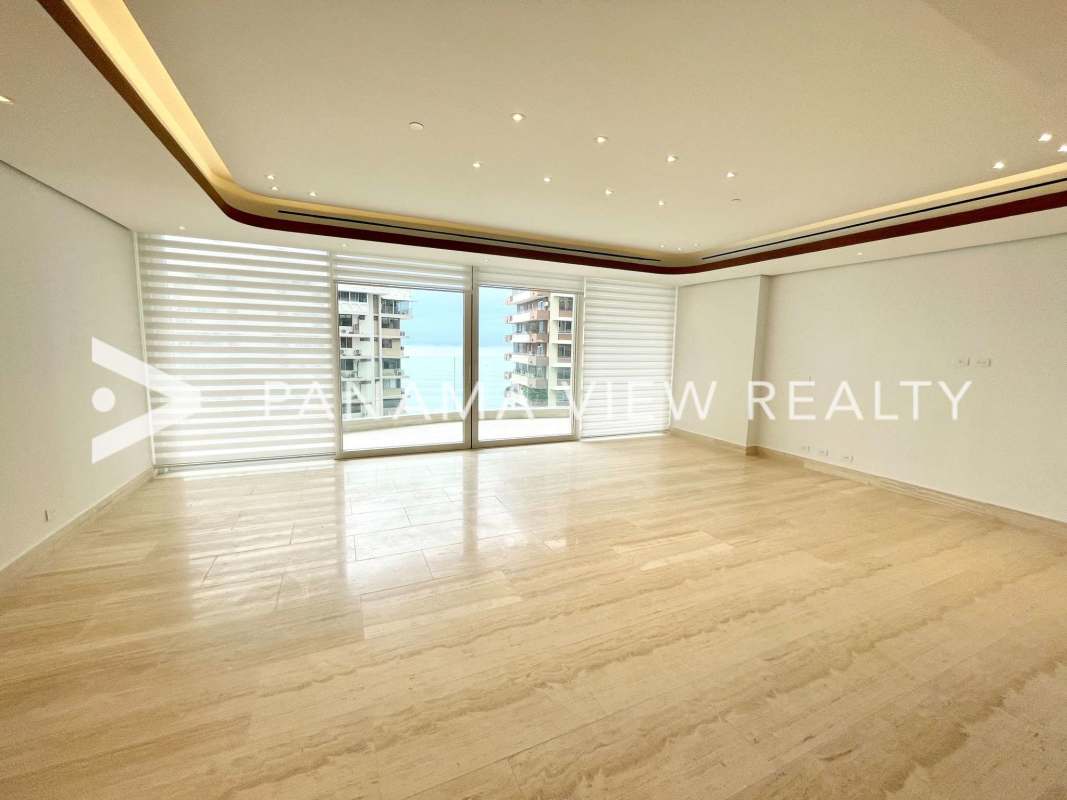 Spacious modern living room with marble floors, floor-to-ceiling windows and skyline view in Punta Paitilla