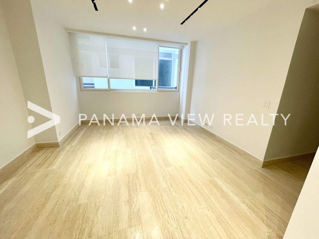 Minimalist living room in The Towers Punta Paitilla with marble floors and large windows