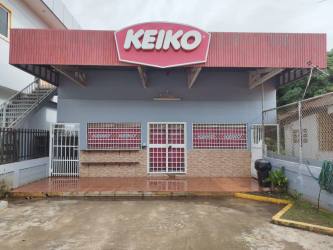 Retail storefront with red awning signage fenced exterior in Chitré Herrera Panama