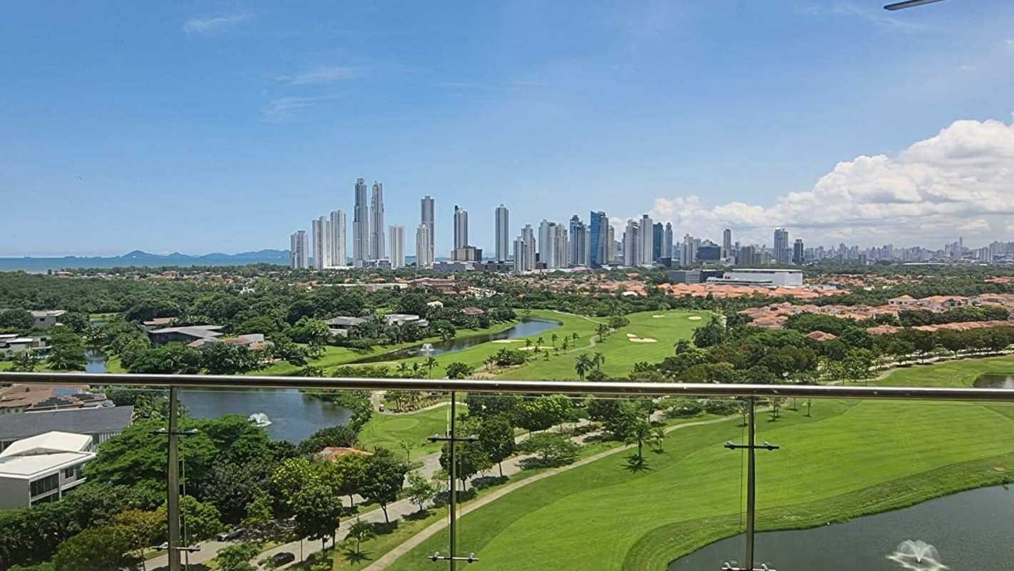 Balcony with glass railing overlooking Nicklaus golf course, skyline and mountains at La Vista Santa María Panama
