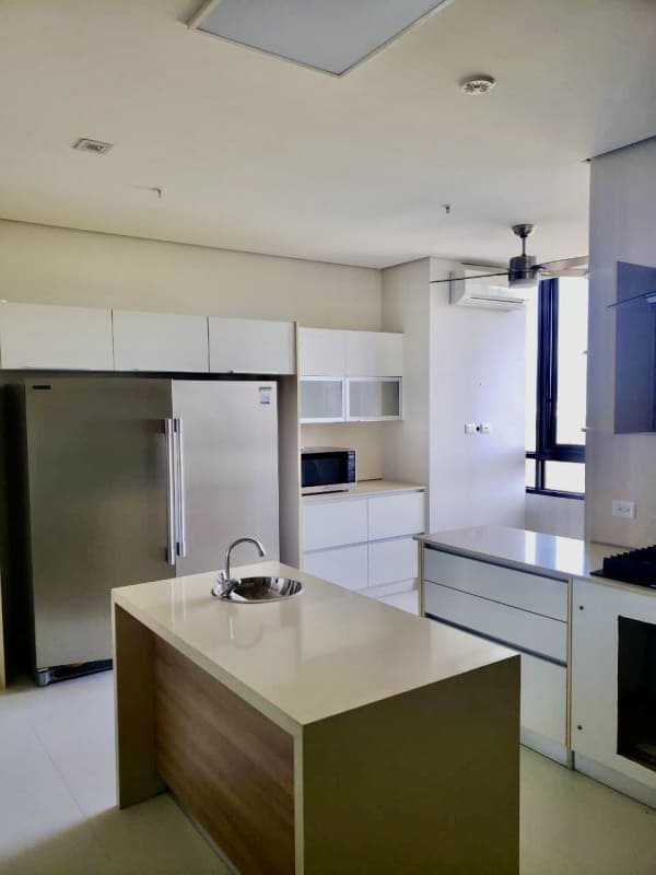 Bright minimalist kitchen with center island and stainless appliances at La Vista Santa María