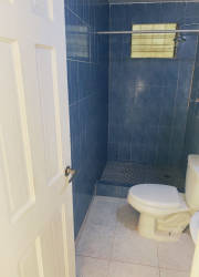Blue tile bathroom with shower and toilet Vacamonte home rental