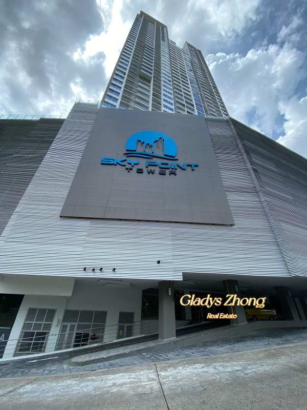 High-rise residential tower Sky Point with modern facade, signage and accessible entrance in Betania Panama City