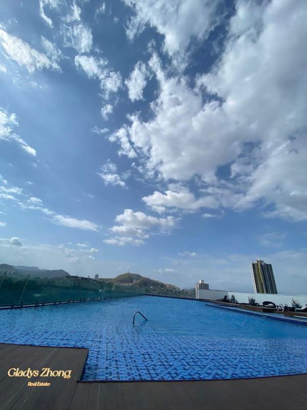 Modern rooftop infinity swimming pool overlooking cityscape and mountains in Sky Point Tower Betania Panama