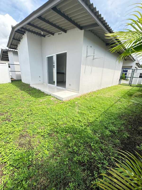 Empty bedroom with built-in closet, sliding doors, and ceramic floors in Costa Sur house for sale