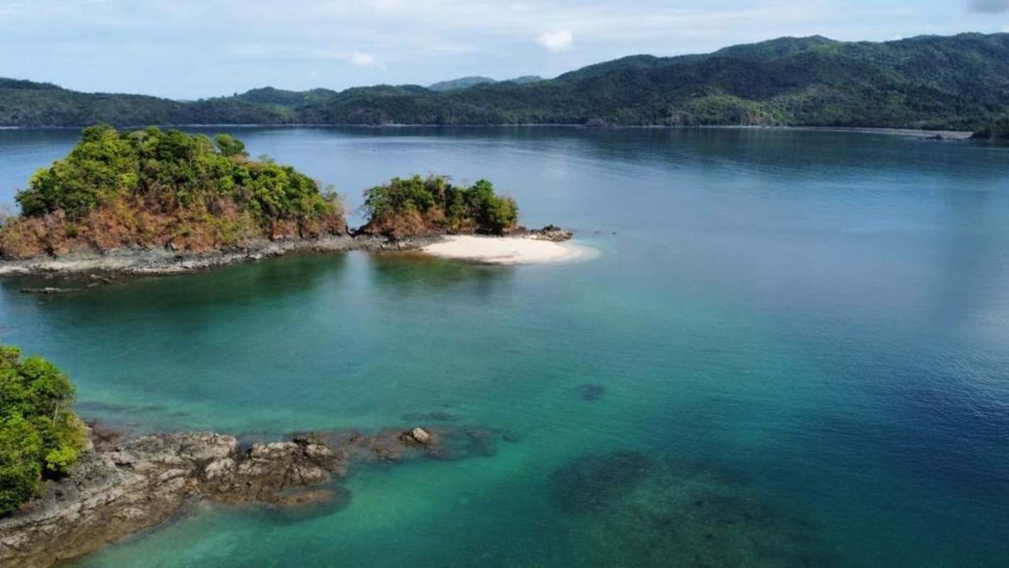 Aerial panoramic of private tropical island for sale with beaches and rainforest Pacific Ocean Panama