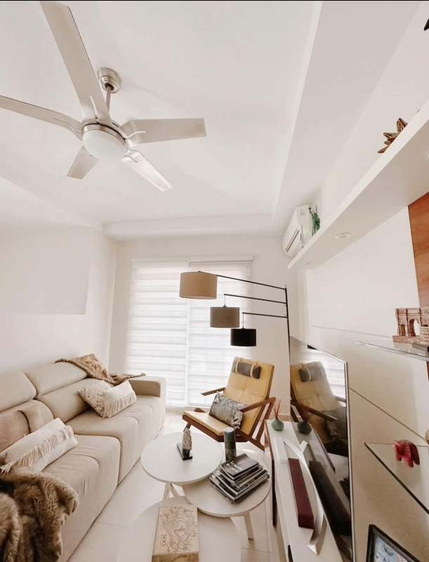 Spacious living room with sofa, AC, large windows, and stylish decor Reserva de Versalles Costa Sur Panama