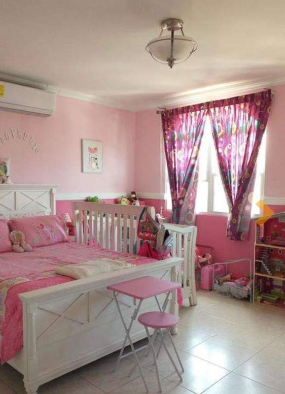 Child's bedroom pink decor with crib and single bed in El Doral Residencial El Bosque Panama