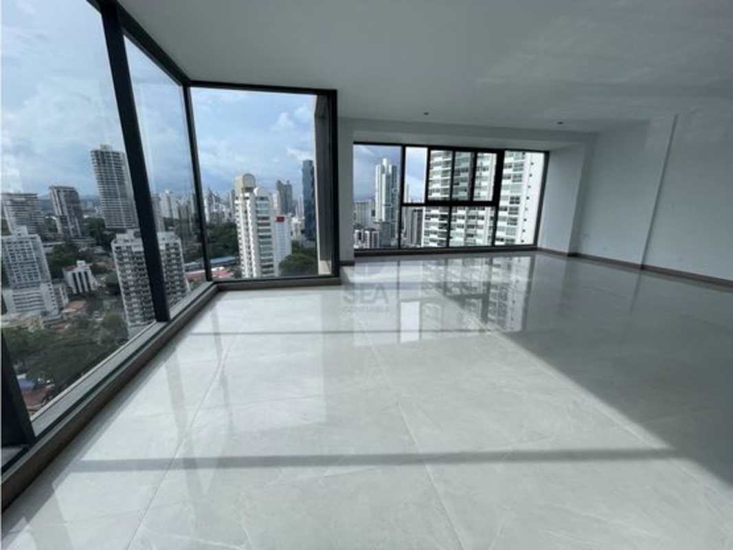 Spacious penthouse living area with floor-to-ceiling windows and skyline views in PH BICSA Tower