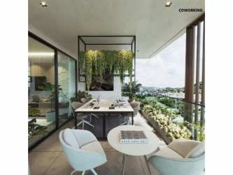 Coworking balcony lounge with plants and city views at Explora Panama Pacifico