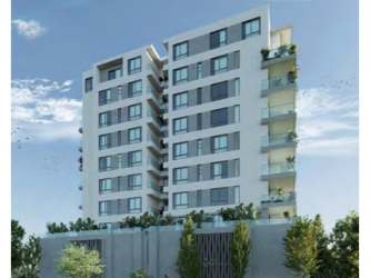 Modern multi-floor apartment building with balconies and lush landscaping in Explora Panama Pacifico