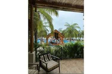 Infinity resort pool surrounded by palm trees in Buenaventura near PH Puntarena Ocean Village