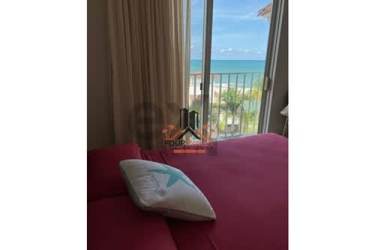 Elegant bedroom with sliding doors leading to balcony overlooking beach at PH Puntarena Ocean Village