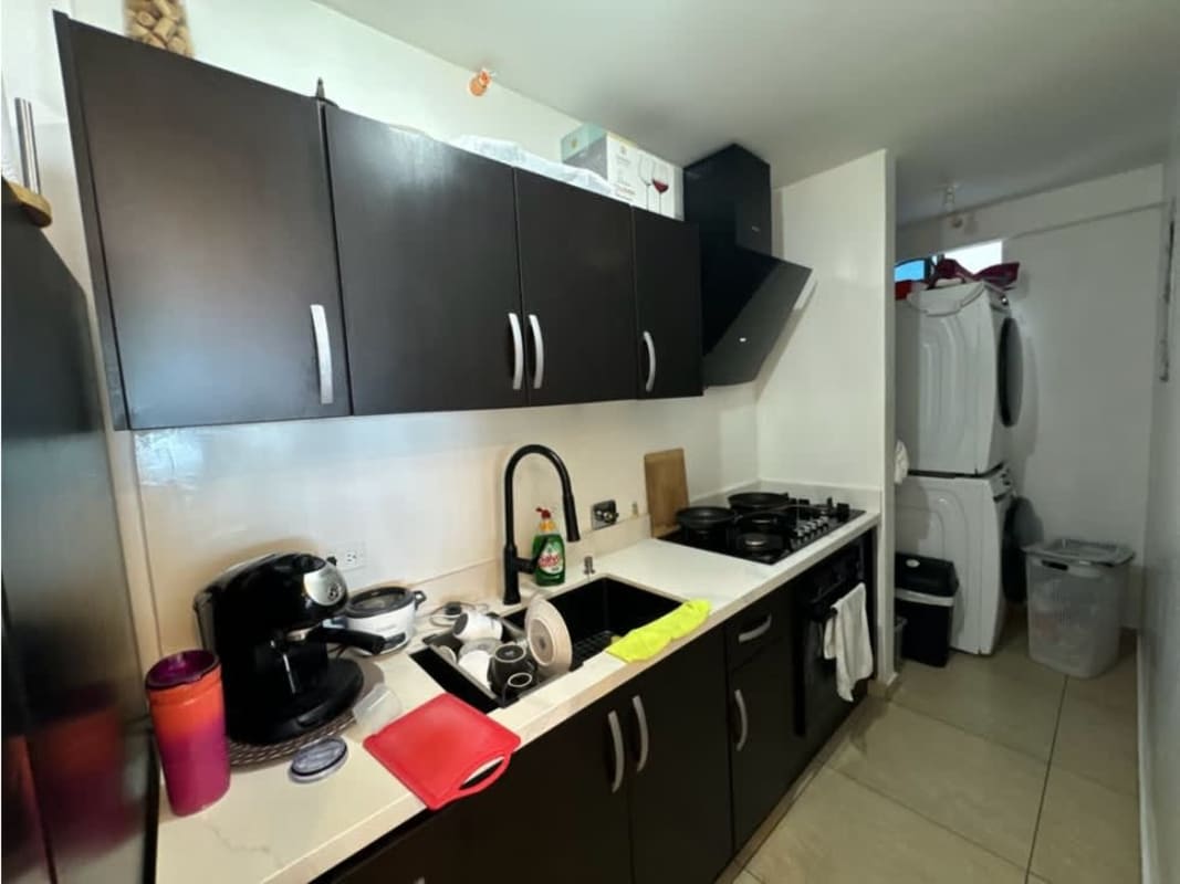 Compact kitchen with black cabinets and built-in laundry PH Vista Park Panama