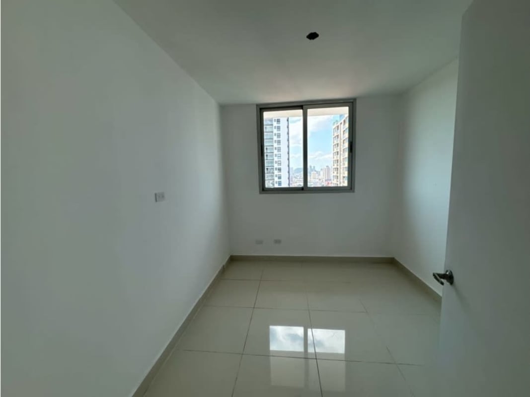 Bright empty bedroom with large window overlooking Panama City skyline PH Teus Tower II